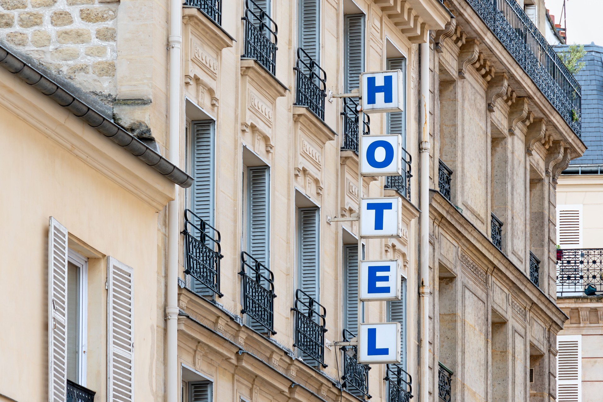 Sign with the word 'HOTEL' on the facade of a building in Paris, France